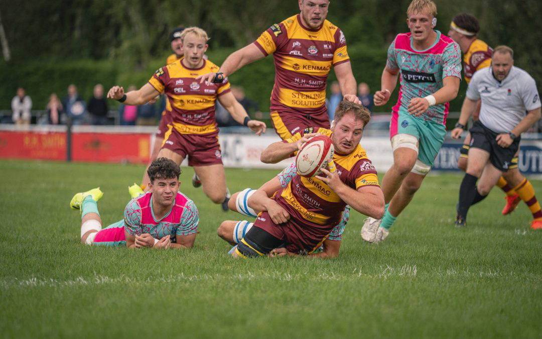 A Sedgley Park ball carrier breaks through the Darlington Mowden Park defence at Park Lane