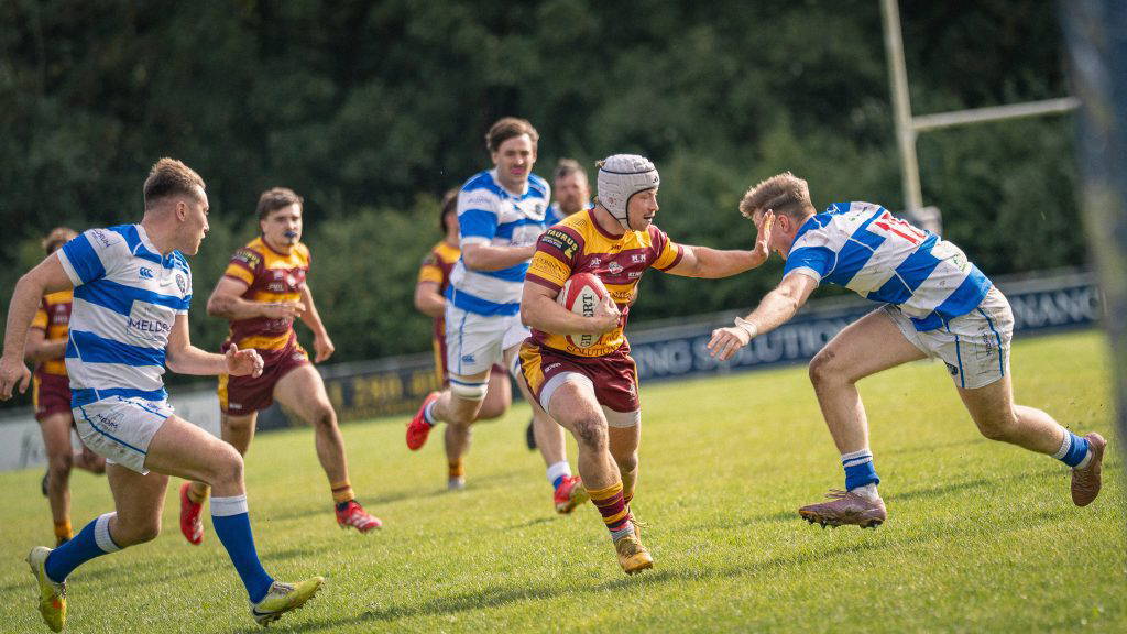 A Sedgley Park Tigers ball carrier hands off a Tynedale defender and breaks through the line