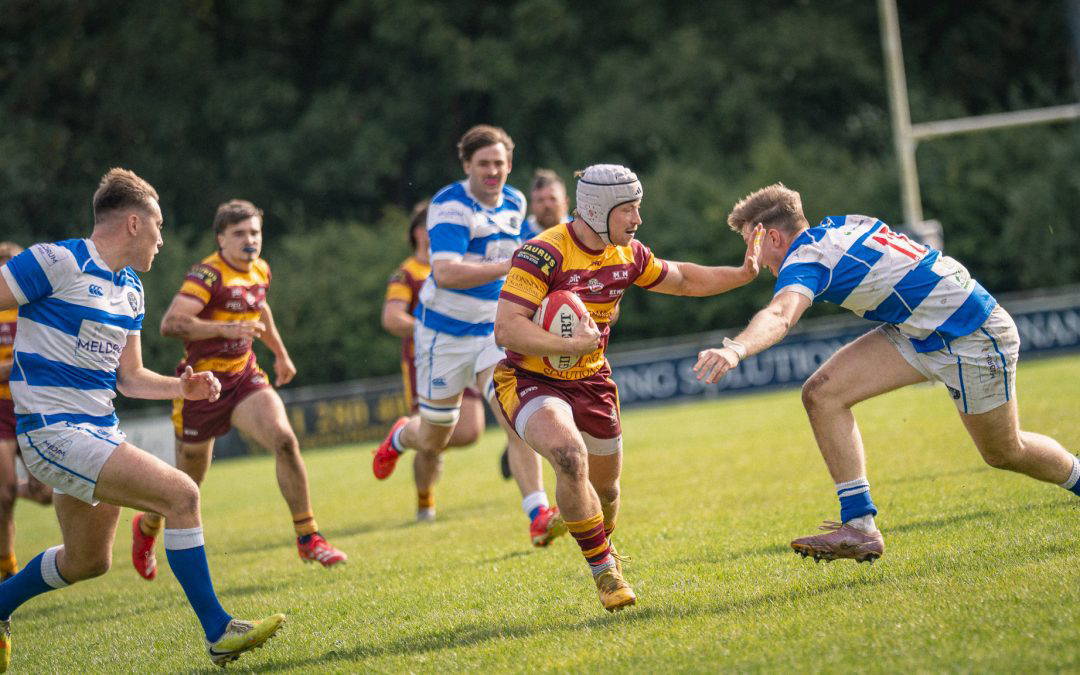 A Sedgley Park Tigers ball carrier hands off a Tynedale defender and breaks through the line