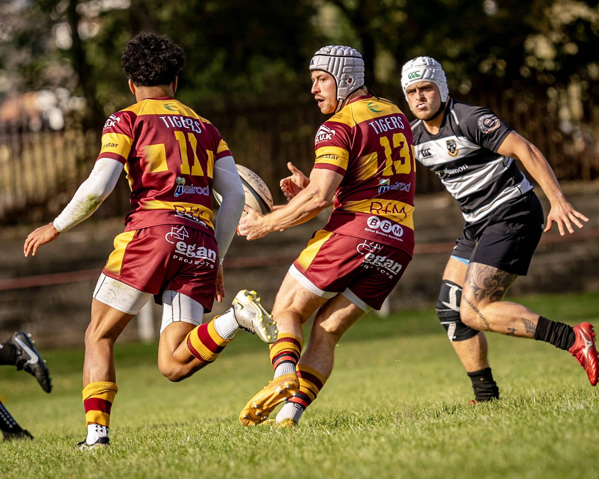Sedgley Park move the ball along the backline at Cross Green against Otley