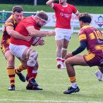 A Chester ball carrier is held up by the Sedgley Park defence at Hare Lane
