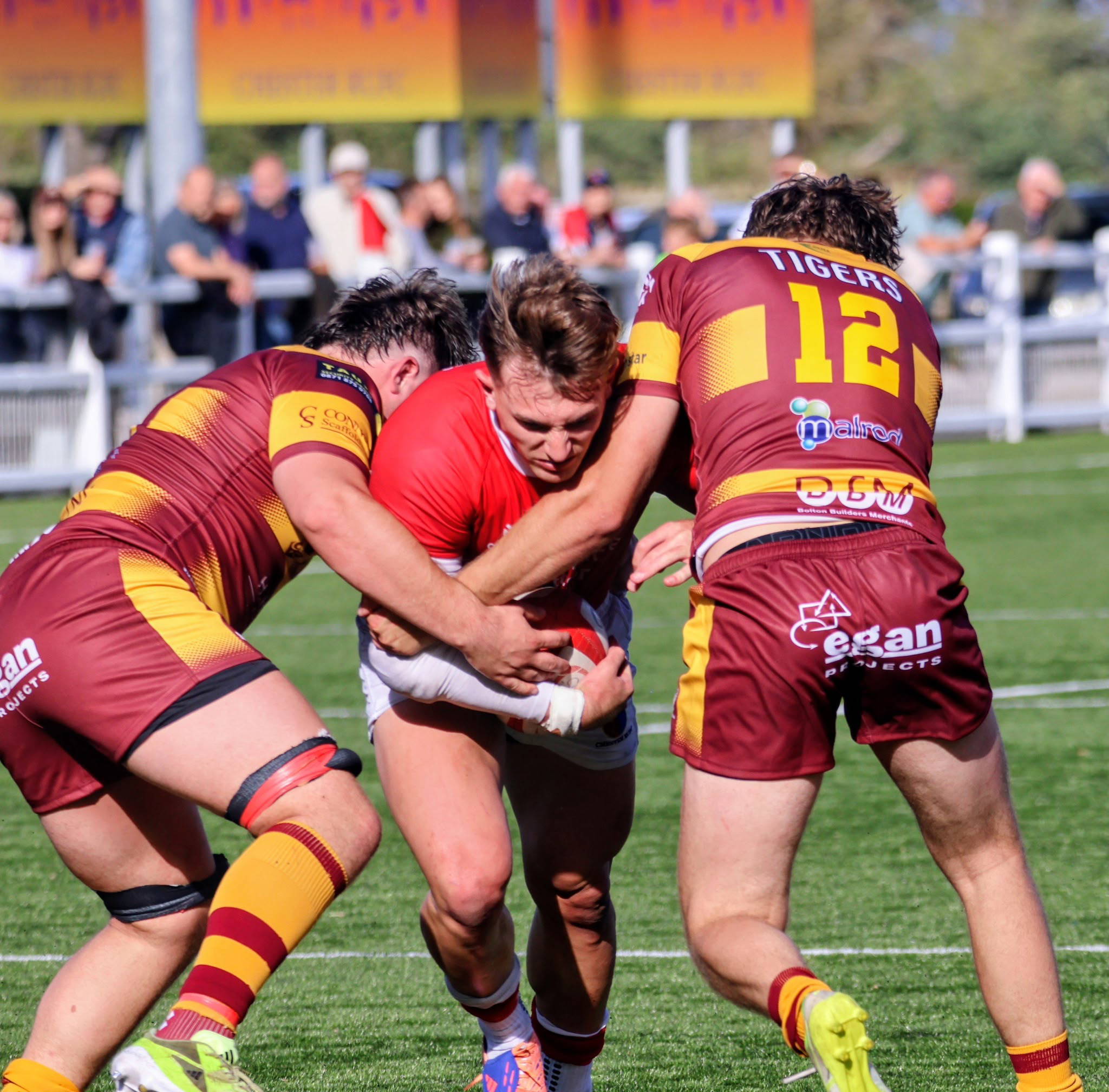Two Sedgley Park defenders wrap up a Chester ball carrier at Hare Lane