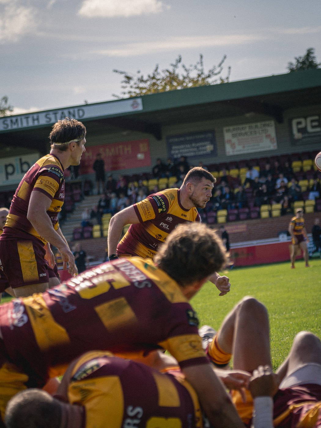 Sedgley Park backs waiting for the ball in front of the David H Smith Stand at Park Lane
