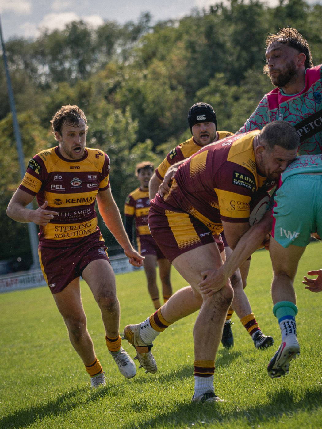 A Sedgley Park forward carrying into contact with support on his shoulder