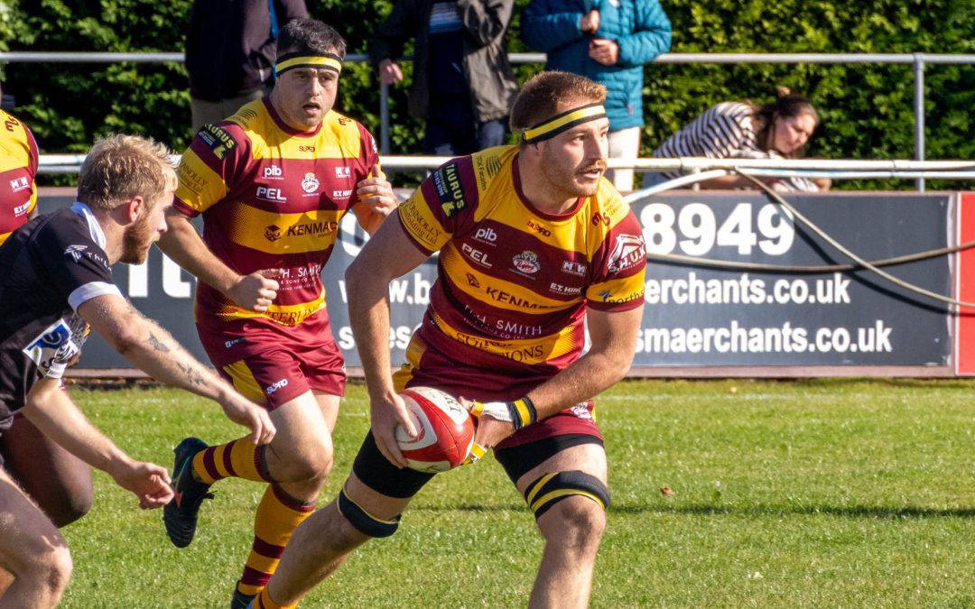 A Sedgley Park forward looks to offload against Huddersfield