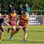 A Sedgley Park forward looks to offload against Huddersfield