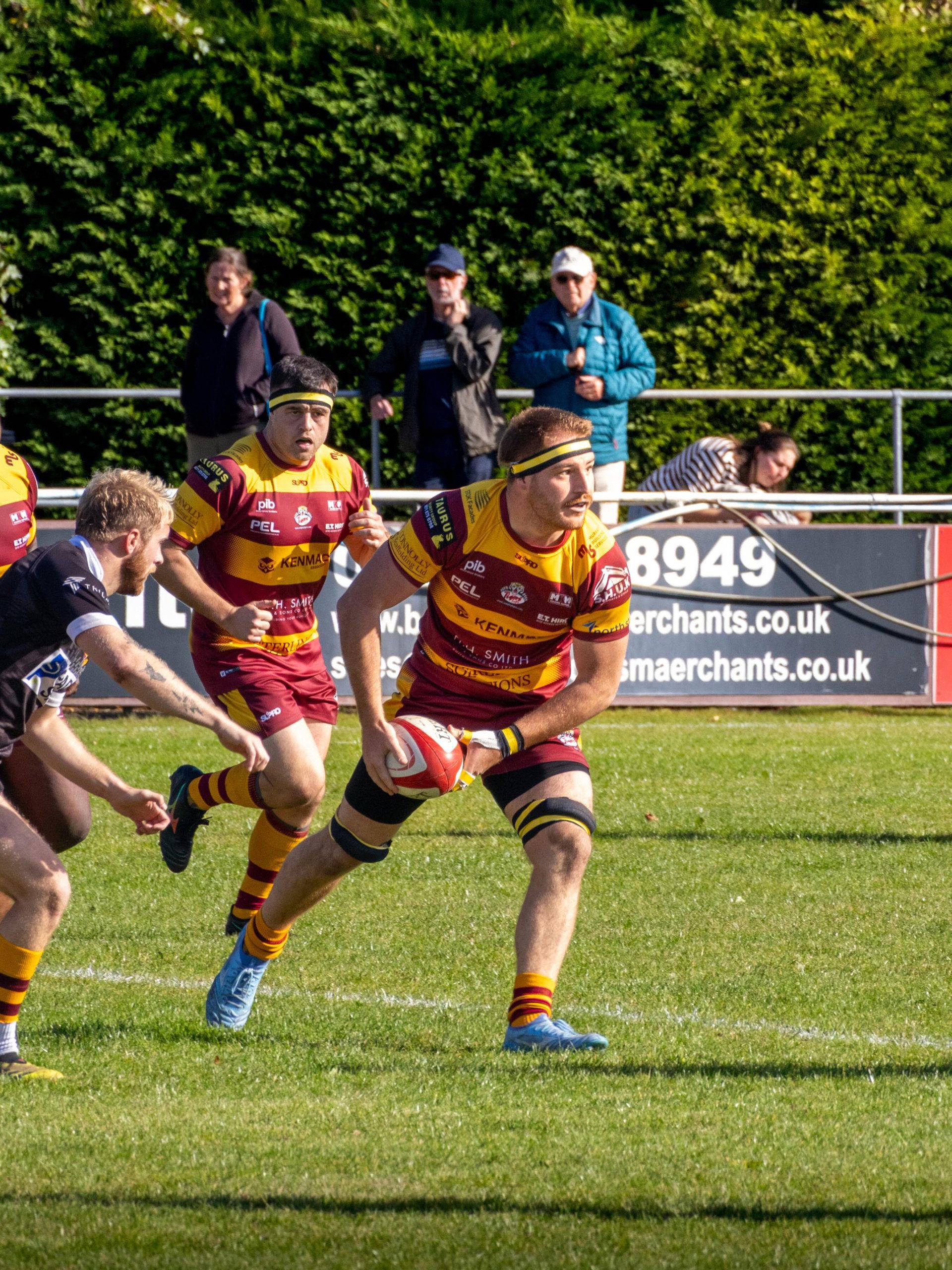 A Sedgley Park forward looks to offload against Huddersfield